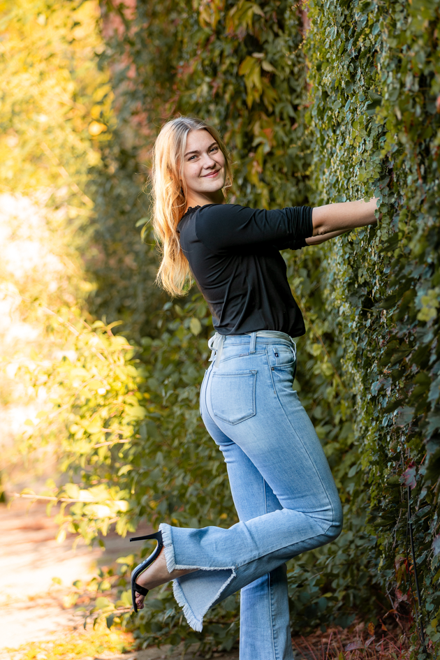 Me pushing the wall away to show off the back of my outfit.